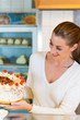 Female baker or pastry chef with torte