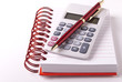 Calculator, notebook and pen