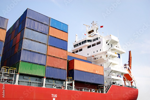 Photo: Stacked containers on ship deck Stacked containers on ship deck