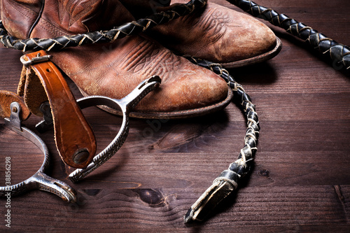 Photo: Cowboy boots,whip and spurs on wood Cowboy boots,whip and spurs on wood
