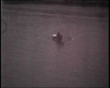Boat in the river with two people, vintage b&w 8mm footage.