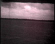 Boat in the river with two people, vintage b&w 8mm footage.