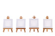 Four blank canvases on easels