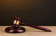 Judge's gavel on wooden table on brown background Judge's gavel on wooden table on brown background
