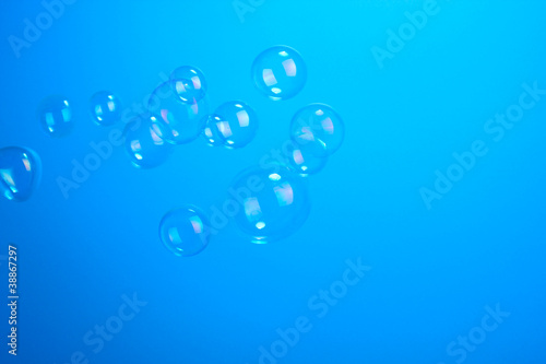 Photo: Soap bubbles on blue background Soap bubbles on blue background