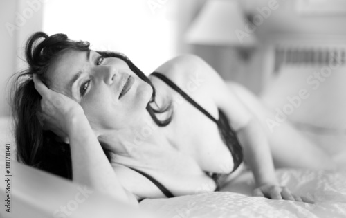 Photo: Sexy middle-aged woman in lingerie, lying in bed Sexy middle-aged woman in lingerie, lying in bed