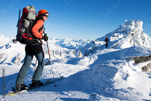 Photo: Young woman doing ski touring in winter Alps Young woman doing ski touring in winter Alps