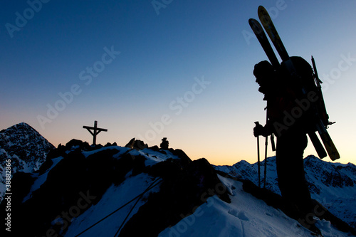 Photo: Young woman with ski in winter mountains Young woman with ski in winter mountains