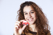 Young woman holding a small car