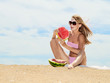 Woman on the beach and eating watermelon Woman on the beach and eating watermelon