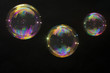 3 party soap bubbles isolated on black. Extremely detailed.