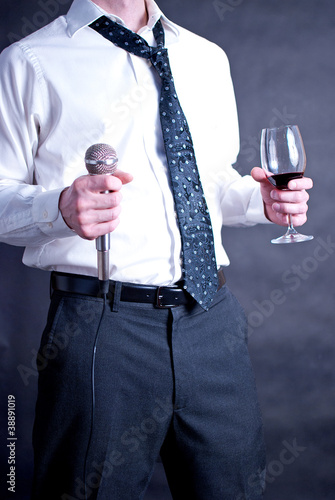 Photo: Man with drink and microphone Man with drink and microphone