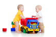 two little children playing with color toys and truck