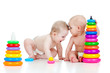 two little children playing with color toys