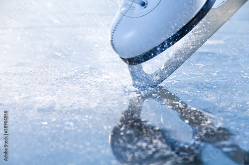 Photo: Woman skates braking ice, frazil flying around Woman skates braking ice, frazil flying around