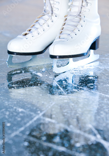 Photo: Portrait version, woman ice skates with reflection Portrait version, woman ice skates with reflection