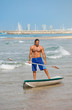 The guy with an oar on a surfboard.