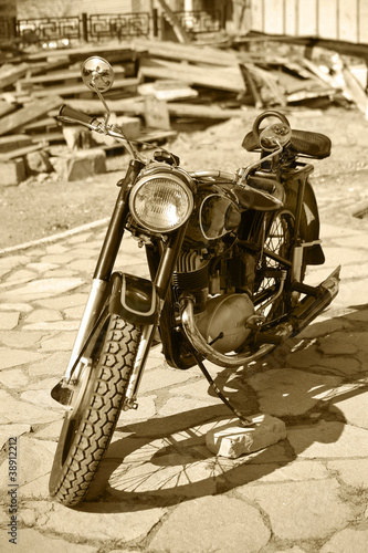 Photo: Retro motorcycle in court yard Retro motorcycle in court yard