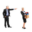 Photo: Angry boss firing a woman in a suit carrying a box of personal i Angry boss firing a woman in a suit carrying a box of personal i