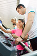 female instructor  with client in gym