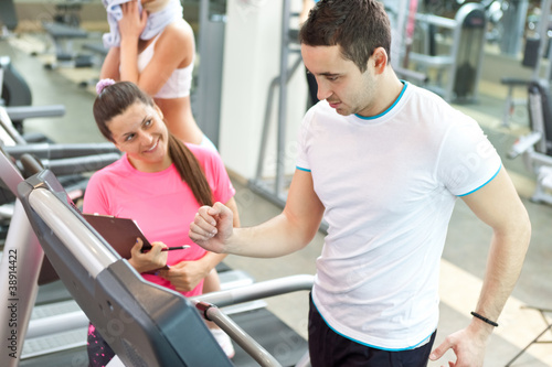 Photo: female trainer with man on treadmill female trainer with man on treadmill