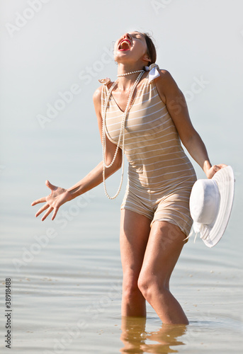 Photo: Woman in white hat cried against the sea Woman in white hat cried against the sea