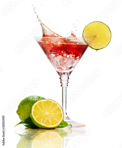 Photo: Red martini cocktail with splash and lime isolated Red martini cocktail with splash and lime isolated