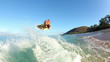 Surfer Catches Wave on Skim Board at the Beach
