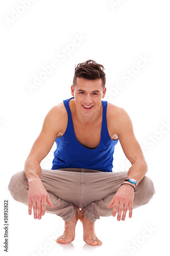 Photo: man squatting down in bare feet man squatting down in bare feet