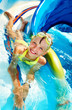 Child on water slide at aquapark.