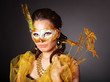 Young woman in carnival costume with mask .