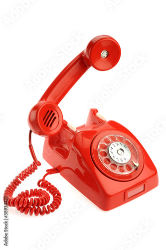 Photo: Red old phone isolated on white background Red old phone isolated on white background