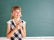 Schoolchild writing on blackboard.