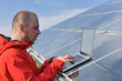engineer using laptop at solar panels plant field engineer using laptop at solar panels plant field