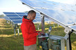 engineer using laptop at solar panels plant field engineer using laptop at solar panels plant field