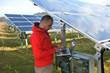 engineer using laptop at solar panels plant field engineer using laptop at solar panels plant field