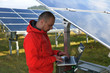 engineer using laptop at solar panels plant field engineer using laptop at solar panels plant field