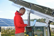 engineer using laptop at solar panels plant field engineer using laptop at solar panels plant field