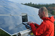 engineer using laptop at solar panels plant field engineer using laptop at solar panels plant field