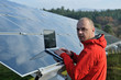 engineer using laptop at solar panels plant field engineer using laptop at solar panels plant field