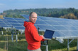 engineer using laptop at solar panels plant field engineer using laptop at solar panels plant field