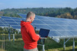 engineer using laptop at solar panels plant field engineer using laptop at solar panels plant field