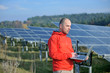 engineer using laptop at solar panels plant field engineer using laptop at solar panels plant field