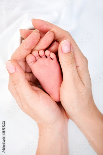 Photo: Clouse-up of newborn baby's foot in mammy's hands Clouse-up of newborn baby's foot in mammy's hands