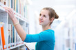 female college student in a library (shallow DOF; color toned im female college student in a library (shallow DOF; color toned im