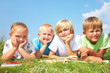 Children read  books in grass