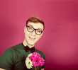 Young smiling man holding a bouquet of flowers