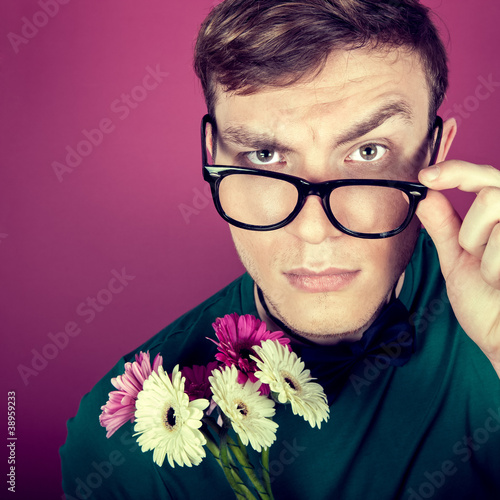 Photo: portrait of a man in big glasses with flowers portrait of a man in big glasses with flowers