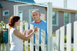 Girl and man near fence wicket