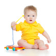 Funny child playing  with musical toys. Isolated on white backgr